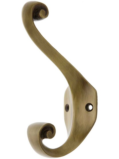 Solid Brass Double Scroll Coat Hook in Antique Brass.